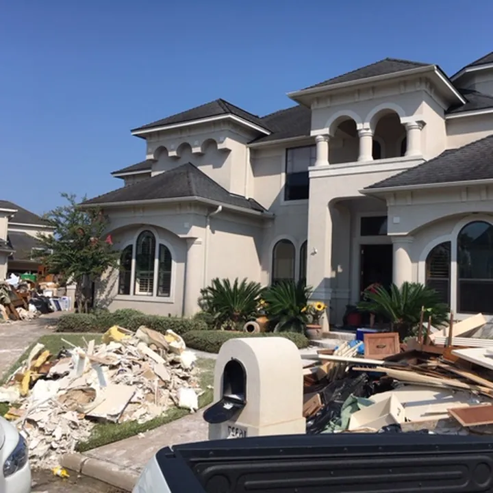 Flood-damaged materials removed to the curb after a Central Texas flood