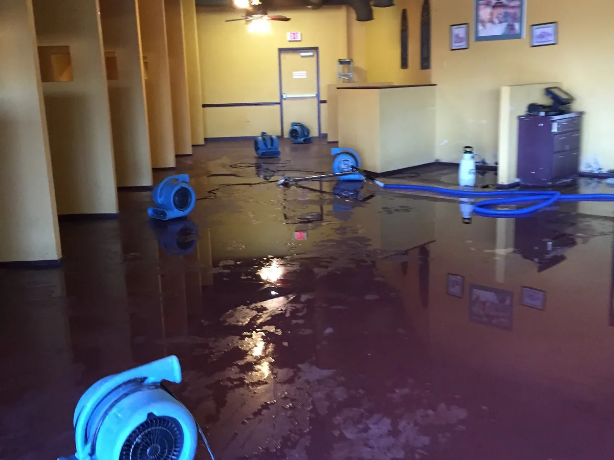 Water damage restoration crew drying a flooded Central Texas home near Dale